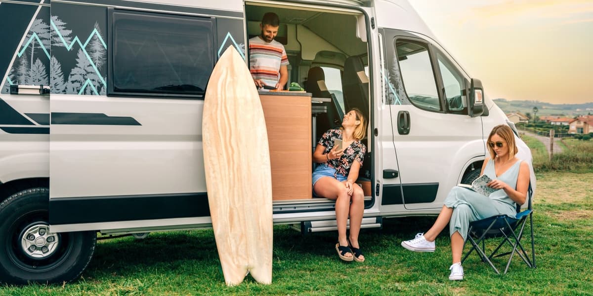 familie zit bij camper