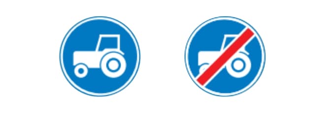 Twee ronde blauwe verkeersborden. Links bord F11: een witte tractor als symbool voor langzaam verkeer, waarmee een verplichte passeerbaan wordt aangegeven. Rechts bord F12: hetzelfde pictogram van een witte tractor, maar met een diagonale rode streep erdoor, waarmee het einde van de passeerbaan wordt aangegeven.