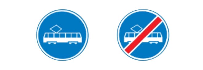 Twee ronde blauwe verkeersborden. Links bord F15: een witte tram, waarmee een rijbaan wordt aangegeven die uitsluitend bedoeld is voor trams. Rechts bord F16: hetzelfde pictogram van een witte tram, maar met een diagonale rode streep erdoor, waarmee het einde van de trambaan wordt aangegeven.
